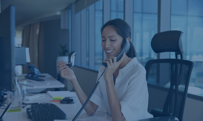 woman talking on a IP Phone in her office