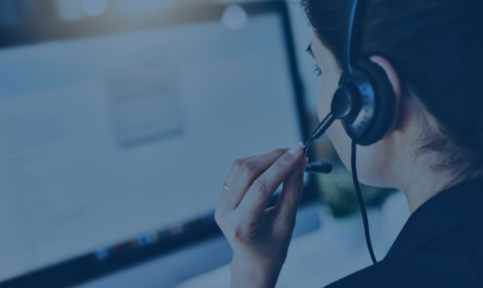 Photo of a woman from behind wearing headphones with a microphone